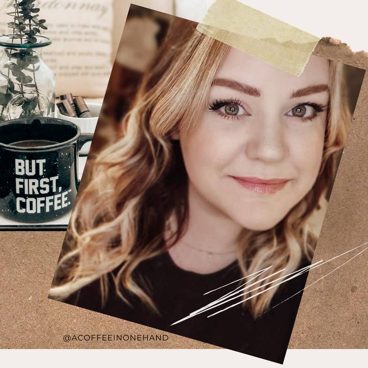 a coffee in one hand